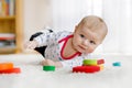 Cute baby girl playing with colorful wooden rattle toy Royalty Free Stock Photo