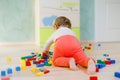 Cute baby girl playing with educational toys. Happy healthy child having fun with colorful different wooden blocks at Royalty Free Stock Photo