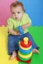 Cute baby girl playing with plastic toy ring Royalty Free Stock Photo