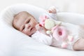 Cute baby girl playing with plush animal toy Royalty Free Stock Photo