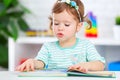 Cute baby girl reading book at home Royalty Free Stock Photo