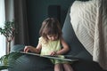 Cute baby girl reading a book at home Royalty Free Stock Photo