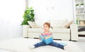 Cute baby girl reading book at home sitting on floor Royalty Free Stock Photo