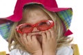 Cute baby girl in a red hat and sunglasses. Royalty Free Stock Photo