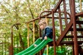 Cute baby girl on a seesaw swing at the playground.Cute baby girl on swing seesaw. on playground in the park outdoors Royalty Free Stock Photo