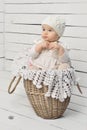 Cute baby girl sitting in a basket Royalty Free Stock Photo