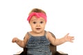 Cute baby girl sitting in a brown chair