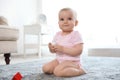 Cute baby girl sitting on floor