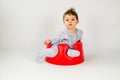 Cute baby girl sitting in a plastic seat Royalty Free Stock Photo