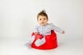 Cute baby girl sitting in a plastic seat Royalty Free Stock Photo