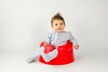 Cute baby girl sitting in a plastic seat Royalty Free Stock Photo