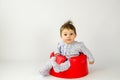 Cute baby girl sitting in a plastic seat Royalty Free Stock Photo