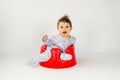 Cute baby girl sitting in a plastic seat Royalty Free Stock Photo