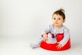 Cute baby girl sitting in a plastic seat Royalty Free Stock Photo