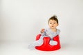 Cute baby girl sitting in a plastic seat Royalty Free Stock Photo