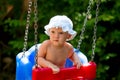 Cute baby girl sitting in a swing Royalty Free Stock Photo