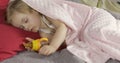 Cute baby sleeping on the bed at home. Little girl sleeping in morning light