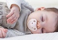 Cute baby girl sleeping over white bedcover Royalty Free Stock Photo