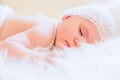 Cute Baby Girl Sleeping Peacefully and Wearing a Knited Wool Hat