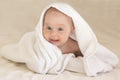 Cute baby girl smiling in white towel. Funny face