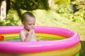 cute baby girl swimming in kid inflatable pool Royalty Free Stock Photo