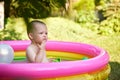 cute baby girl swimming in kid inflatable pool Royalty Free Stock Photo