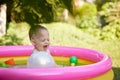 cute baby girl swimming in kid inflatable pool Royalty Free Stock Photo