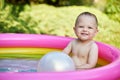 cute baby girl swimming in kid inflatable pool Royalty Free Stock Photo