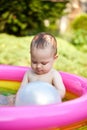 cute baby girl swimming in kid inflatable pool Royalty Free Stock Photo