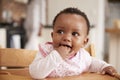 Cute Baby Girl Wearing Bib Sitting In High Chair