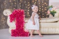 Cute baby girl 1-2 year old sitting on floor with pink balloons in room over white. Isolated. Birthday party. Celebration. Happy b Royalty Free Stock Photo