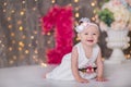 Cute baby girl 1-2 year old sitting on floor with pink balloons in room over white. Isolated. Birthday party. Celebration. Happy b Royalty Free Stock Photo