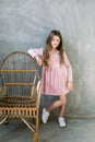 Cute baby girl 5-6 year old wearing stylish pink dress overgrey background. Looking at camera. Birthday party Royalty Free Stock Photo