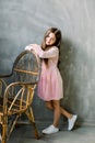 Cute baby girl 5-6 year old wearing stylish pink dress overgrey background. Looking at camera. Birthday party Royalty Free Stock Photo