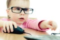 Cute baby with glasses looking into the laptop Royalty Free Stock Photo