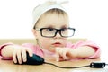 Cute baby with glasses looking into the laptop Royalty Free Stock Photo