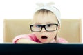 Cute baby with glasses looking into the laptop Royalty Free Stock Photo