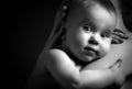 Cute baby at hands of the mother in an embrace, monochrome