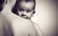 Cute baby at hands of the mother in an embrace, monochrome