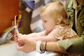 Cute baby and dad washing their hands with soap in bathroom together. Hygiene for little child. Father`s involvement in raising