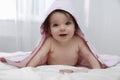 Cute little baby in hooded towel after bathing on bed at home Royalty Free Stock Photo