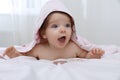 Cute little baby in hooded towel after bathing on bed at home Royalty Free Stock Photo