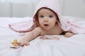 Cute little baby in hooded towel after bathing on bed at home Royalty Free Stock Photo