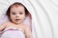 Cute little baby in hooded towel after bathing on bed, top view. Space for text Royalty Free Stock Photo