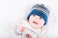 Cute baby in a knitted sweater and blue hat Royalty Free Stock Photo