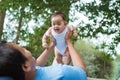 Cute baby laughs when his father lift