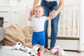 Cute baby learning how to walk with mother at home Royalty Free Stock Photo