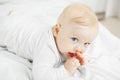 Cute baby lies with thumb in mouth Royalty Free Stock Photo