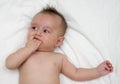 Cute baby lies on a white background