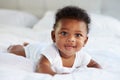 Cute Baby Lying On Tummy In Parent's Bed Royalty Free Stock Photo